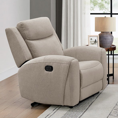 Beige recliner chair in a living room setting with a lamp and decor items.