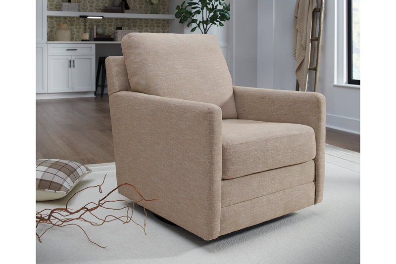 Beige armchair in a room with a desk and plants