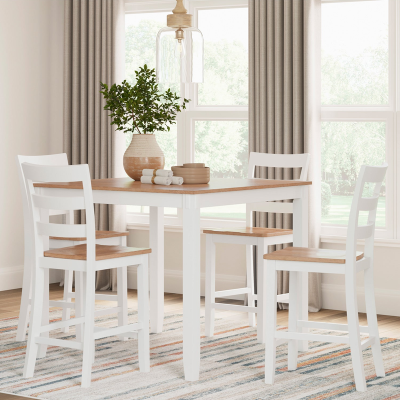 Dining area with a white table and chairs in front of large windows.