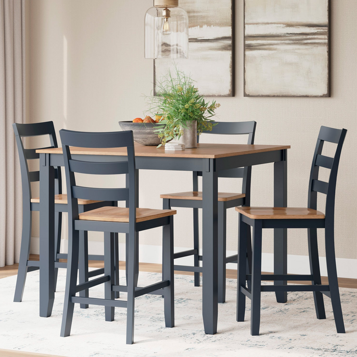 Dining room set with a table and four chairs in a well-lit room.