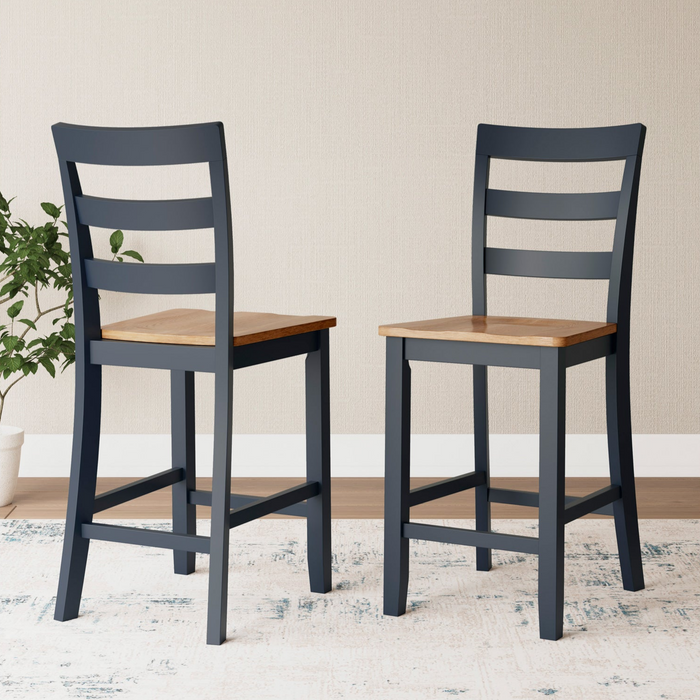 Two slate bar stools with wooden seats in a room setting.