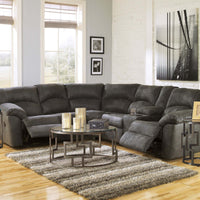 Gray sectional sofa in a living room with a coffee table and decorative items.