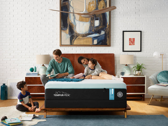 Family sitting on Tempur-Pedic mattress