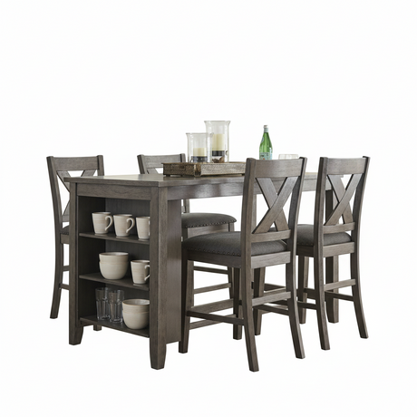 A 5-piece counter height dining table set with a gray wood-grain finish, featuring four matching high-back chairs with X-backs and a small storage shelf under the table. The set is styled with white ceramic mugs, glasses, candles, and a green glass bottle on a solid white background.