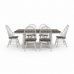A 7-piece dining set featuring a rectangular table with a dark brown wood top and a distressed white base, surrounded by six matching spindle-back chairs with white frames and dark brown seats, shown on a solid white background.
