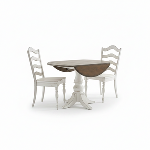 A round drop-leaf dining table with a whitewashed pedestal base and two matching white ladder-back chairs, shown on a clean white background.