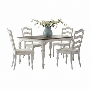 A 5-piece dining set featuring a rectangular table with a dark brown wood top and distressed white turned legs, surrounded by four matching ladder-back chairs in distressed white. A light blue ceramic vase filled with white blossoms sits on the table.