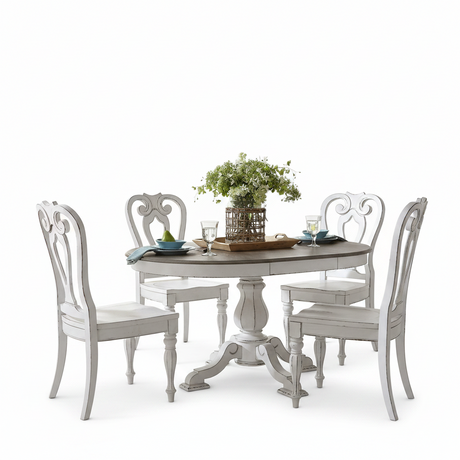 A white distressed round dining table with four matching high-back chairs, styled with a green floral centerpiece and place settings on a clean white background.