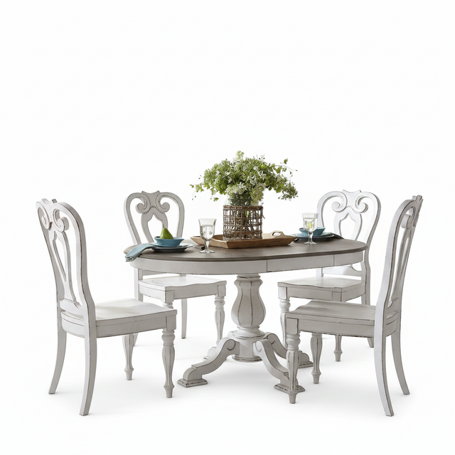 A white distressed round dining table with four matching high-back chairs, styled with a green floral centerpiece and place settings on a clean white background.