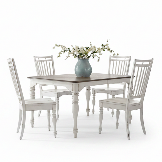 A white distressed dining set featuring a square table with a dark wood top and four matching high-back chairs, styled with a light blue vase of white flowers on a clean white background.
