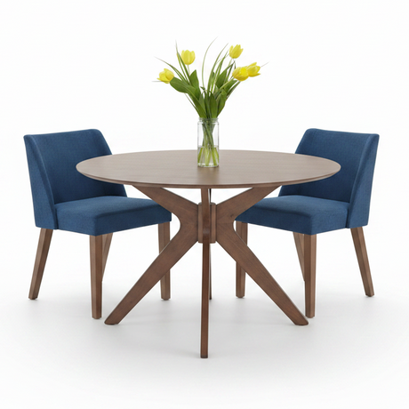 A round dining table with a light brown wood-grain top and X-shaped wooden legs, accompanied by two blue upholstered chairs. A clear glass vase filled with yellow tulips sits in the center of the table on a clean white background.