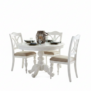 A white round pedestal dining table with four matching white chairs featuring beige upholstered seats, set on a clean white background with tableware and a decorative centerpiece.
