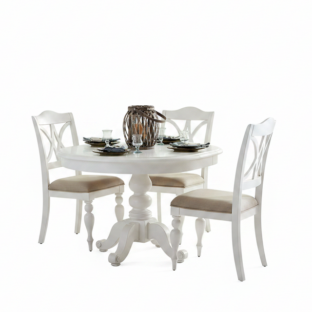 A white round pedestal dining table with four matching white chairs featuring beige upholstered seats, set on a clean white background with tableware and a decorative centerpiece.