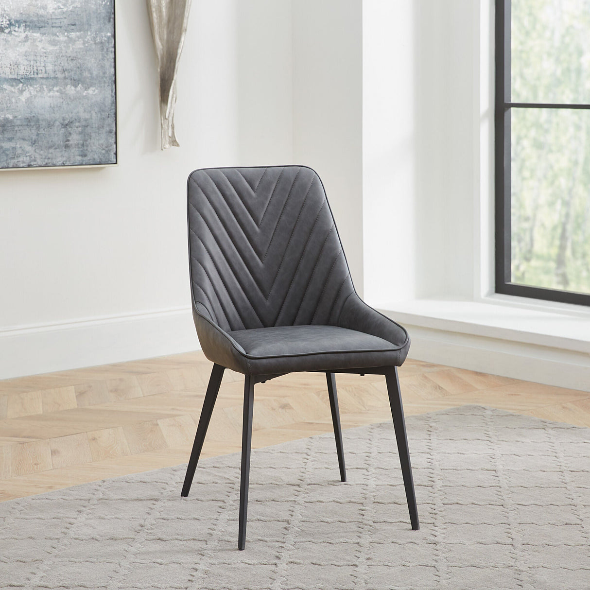 A room setting featuring Lucia Charcoal Upholstered Side Chair