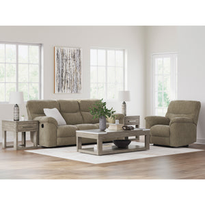 Living room with beige sofa, armchair, and coffee table in a bright room.