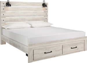 A light grayish wood platform bed frame with a slatted headboard, white mattress, two white pillows, and two built-in storage drawers with black handles at the base. Black wall-mounted lamps are attached above the headboard.