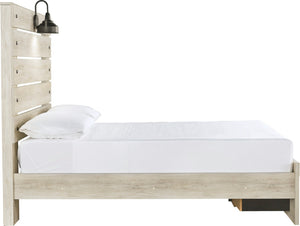 A light natural wood platform bed frame with a tall slatted headboard, shown with white bedding and a white pillow against a solid white background. A black wall-mounted lamp is attached to the headboard.