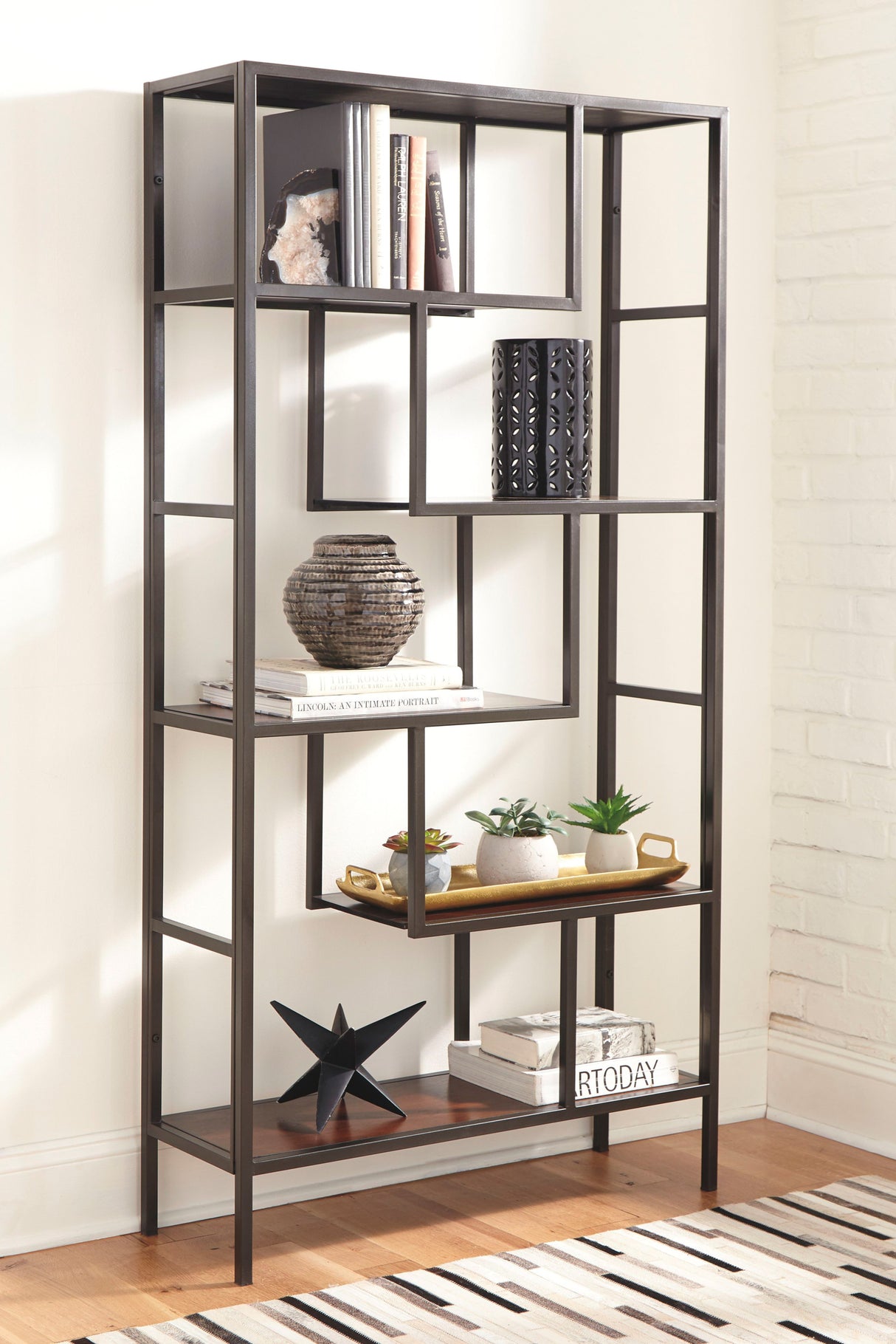 Modern bookshelf with decorative items against a white wall