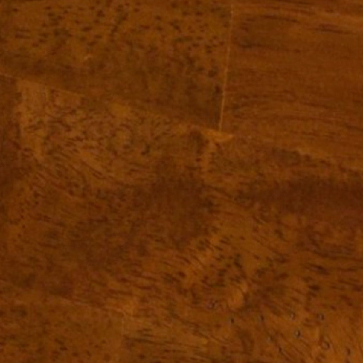 A close-up view of a warm medium-brown wood surface with visible grain and plank seams, shown against a white border at the top and bottom.