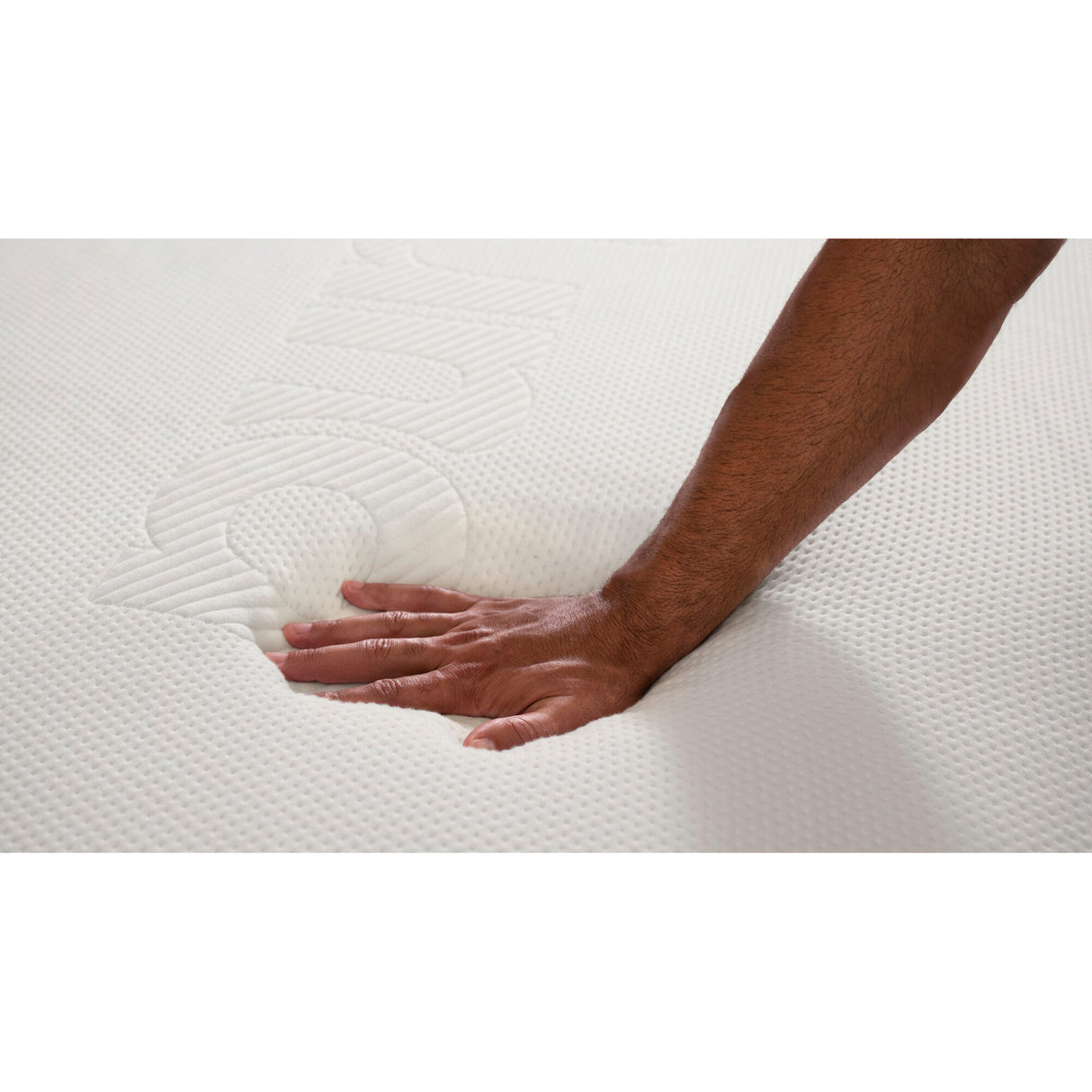 Hand pressing into The Purple Mattress