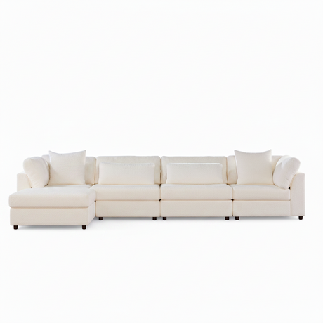 A modern sectional sofa in off-white upholstery with matching throw pillows, shown from a straight-on angle against a plain white background.