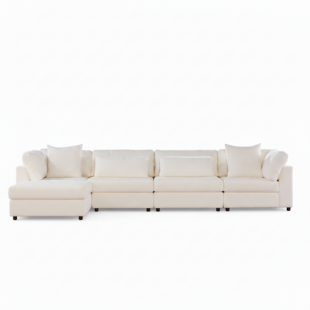 A modern sectional sofa in off-white upholstery with matching throw pillows, shown from a straight-on angle against a plain white background.
