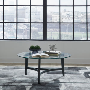 A room setting featuring Capri Glass Round Coffee Table