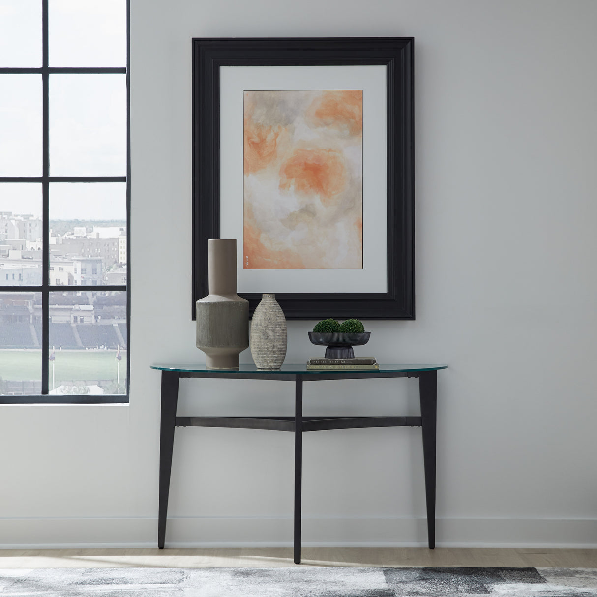 A room setting featuring Capri Glass Sofa Table