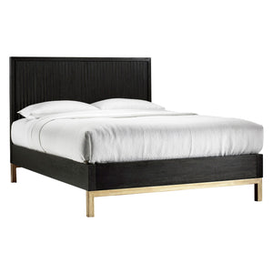Black bed frame with gold legs and white bedding on a white background