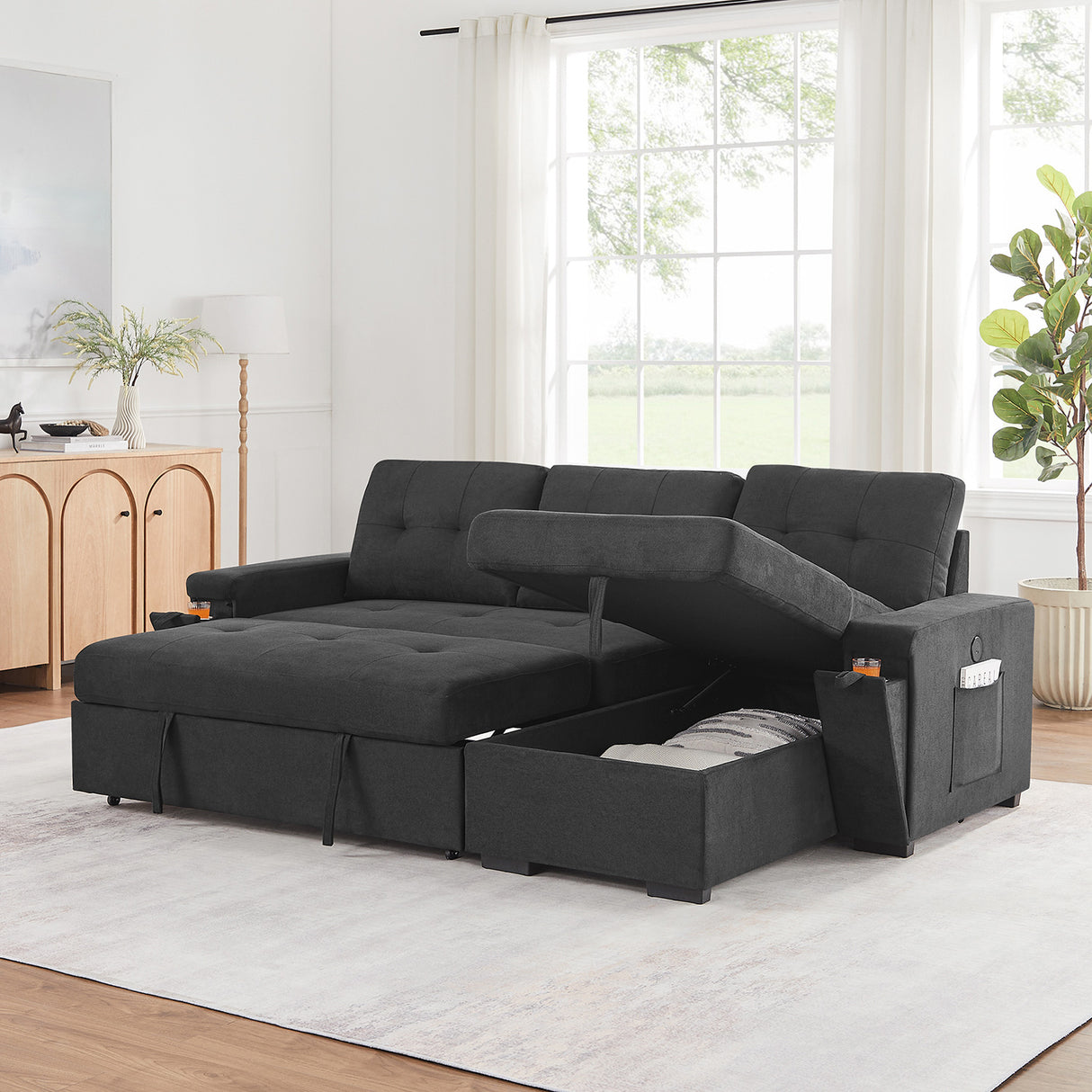 A room setting featuring Toby Black Sleeper Chaise Sofa