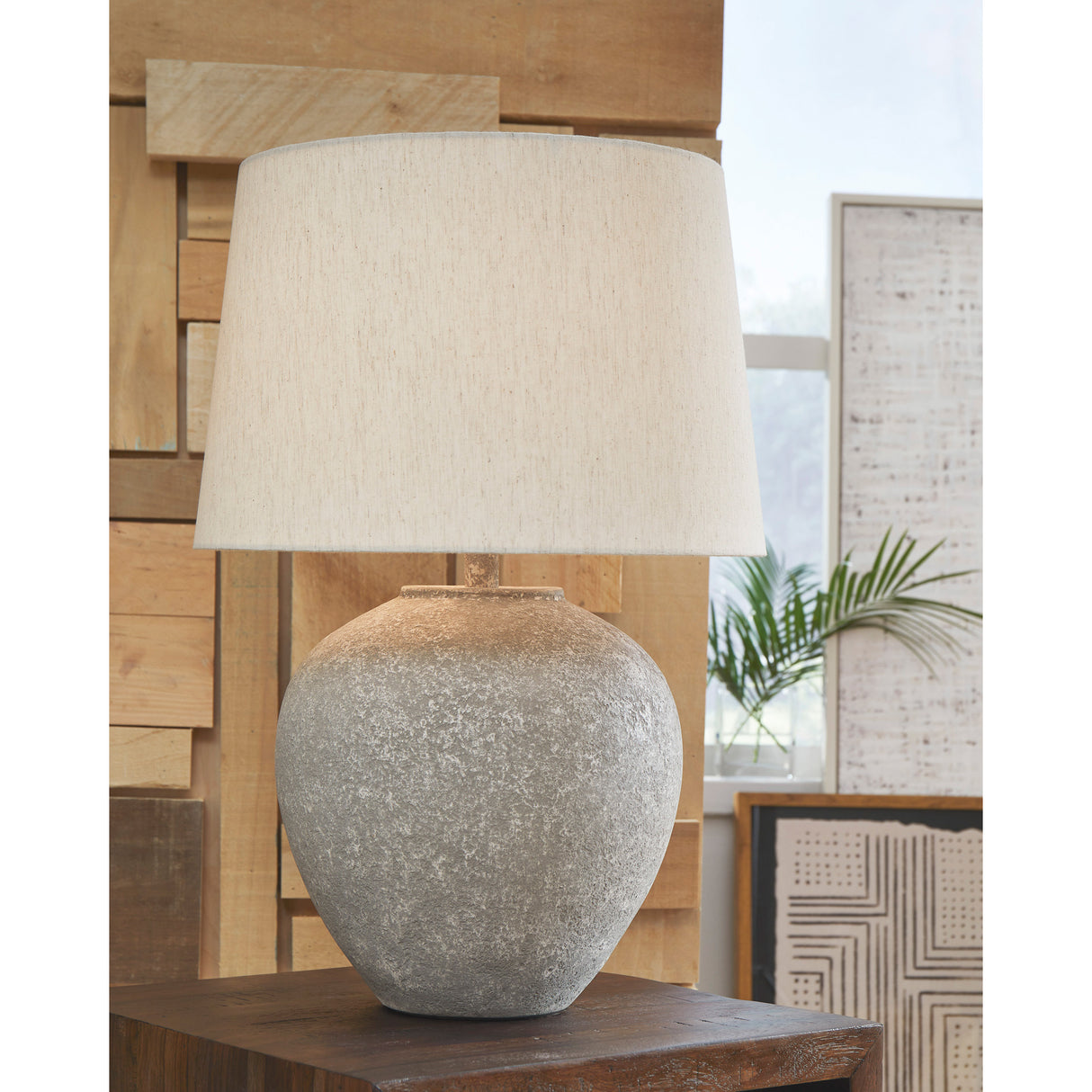A room setting featuring Dreward Distressed Gray Table Lamp