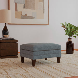 A room setting featuring Eleanora Blue Ottoman