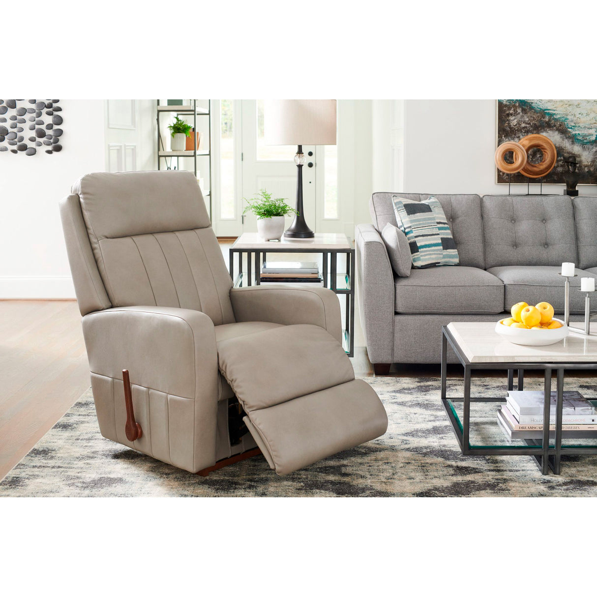 Beige recliner chair in a living room setting with a gray sofa and coffee table.