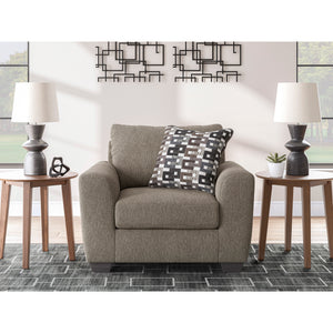 A room setting featuring Triston-Peaks Suede Chair and a Half