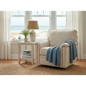 A room setting featuring Warren Twine Nail Head Swivel Chair