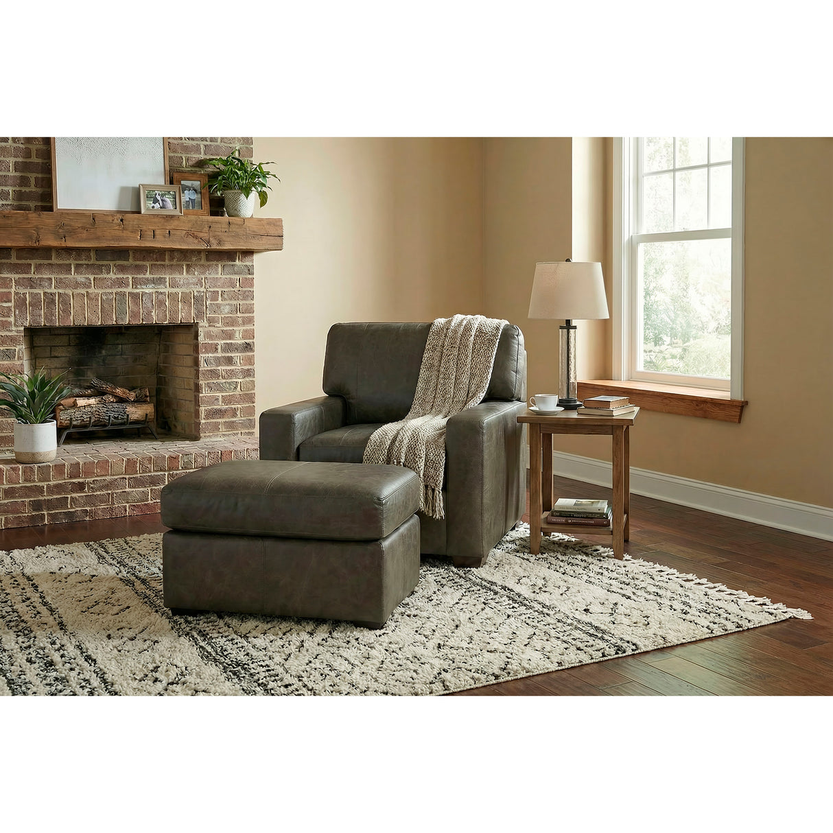 A room setting featuring Merritt Carbone Feather Blend Leather Ottoman