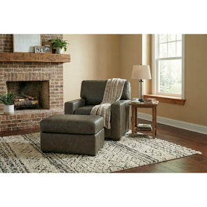 A room setting featuring Merritt Carbone Feather Blend Leather Ottoman