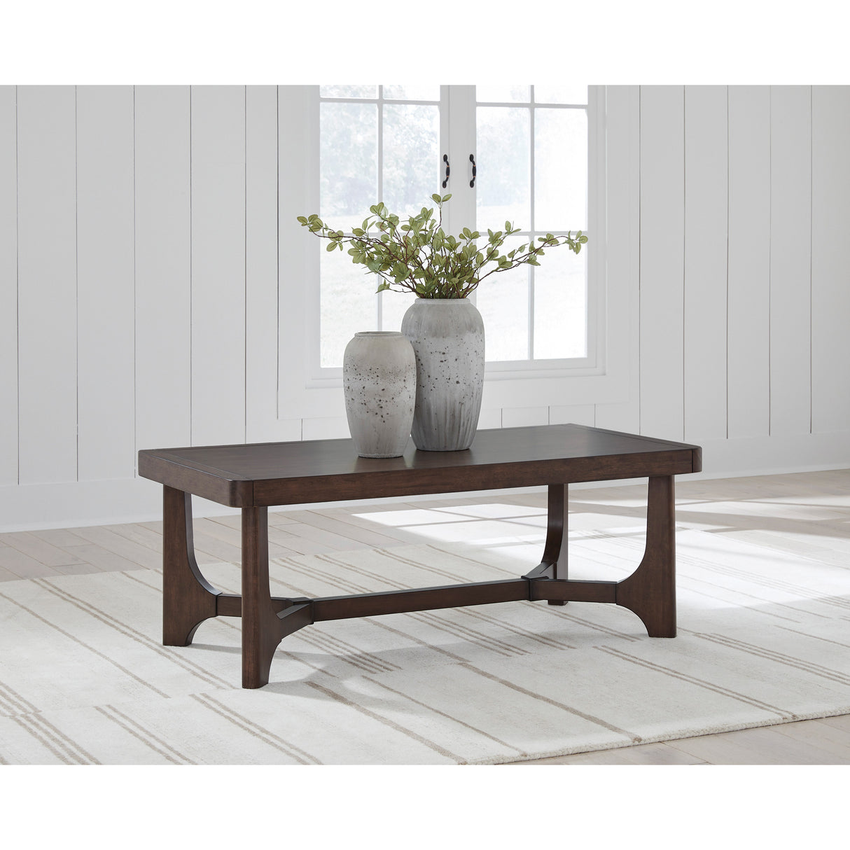 A room setting featuring Korestone Dark Brown Cocktail Table