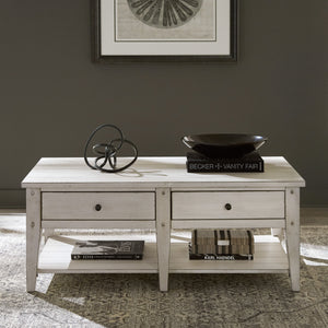 A room setting featuring Lake House Weathered White Coffee Table