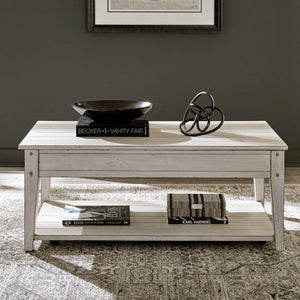 A room setting featuring Lake House Weathered White Lift Top Coffee Table