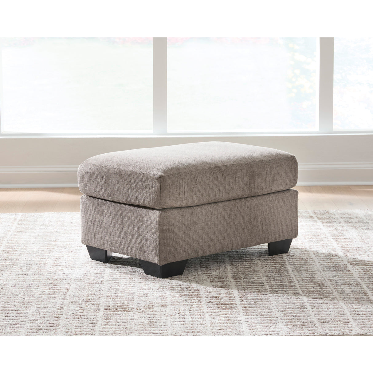 A room setting featuring Loreo Truffle Ottoman