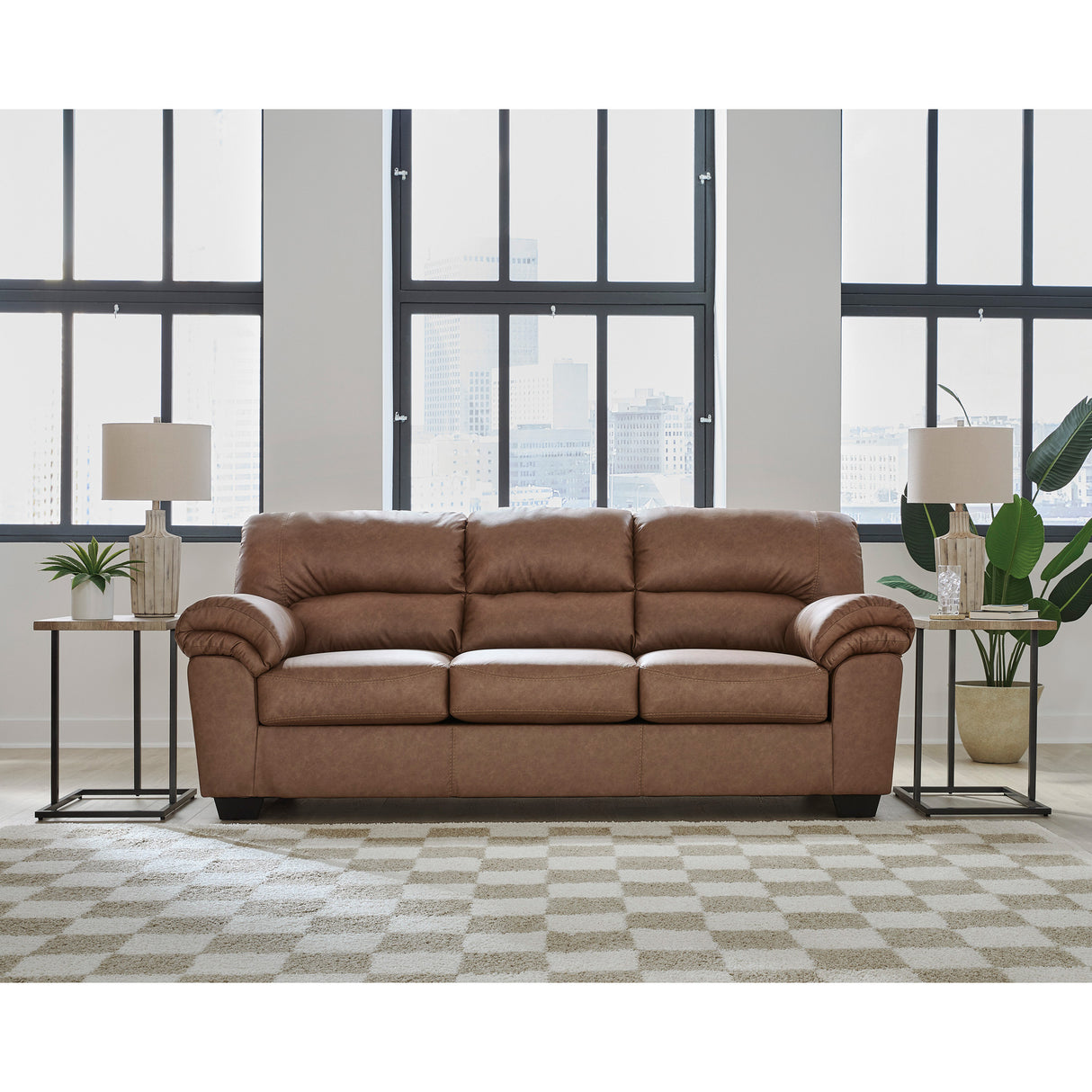 A room setting featuring Whitlock Caramel Sofa