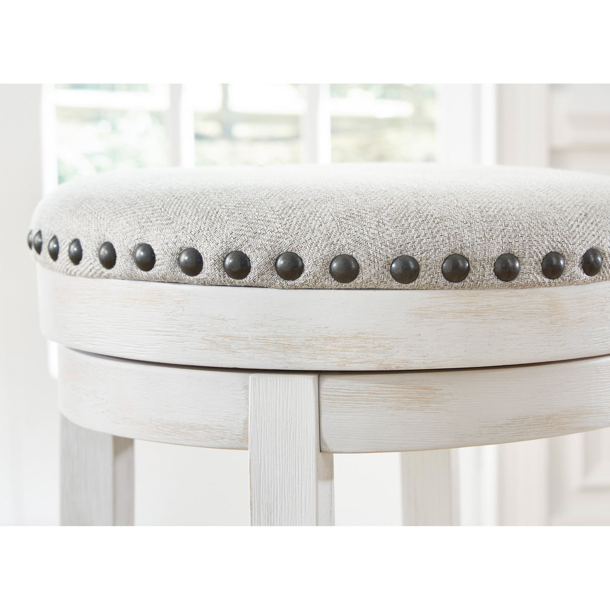 Detail view of Valebeck Antique White Backless Swivel Counter Stool