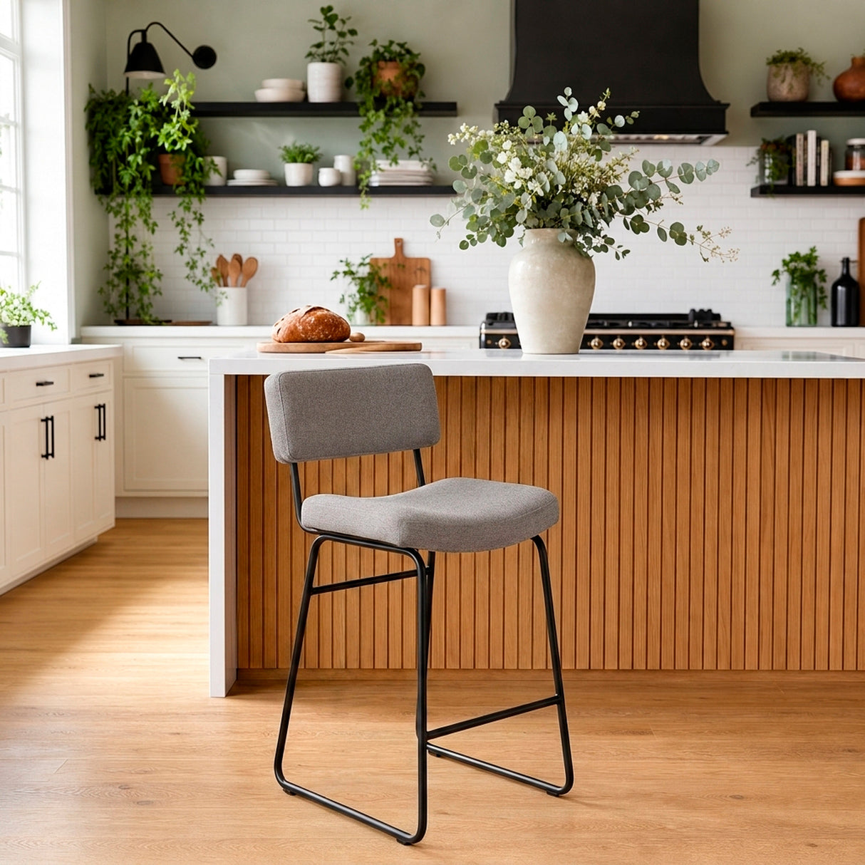 A room setting featuring Malory Frosted Flint Counter Stool