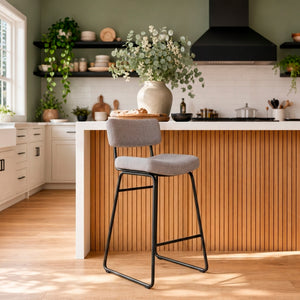 A room setting featuring Malory Frosted Flint Bar Stool