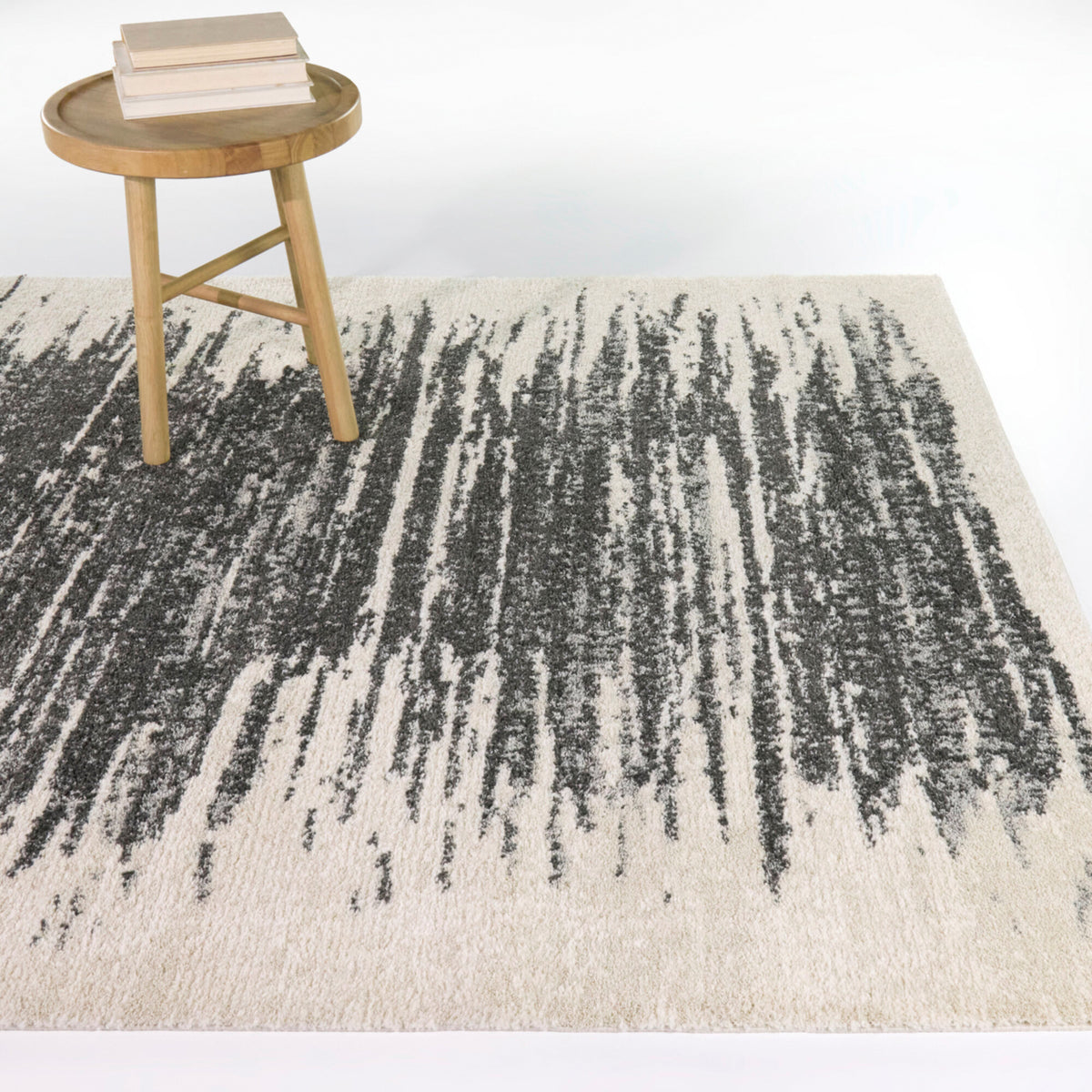 A room setting featuring Axl Abstract Charcoal 8x10 Rug