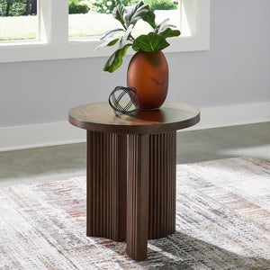 A room setting featuring Korestone Brown Round End Table