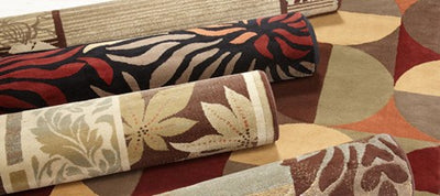 Collection of patterned rugs on a wooden floor
