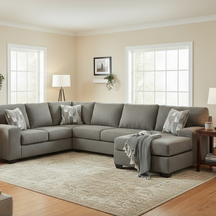 Gray sectional sofa with patterned cushions on a white background