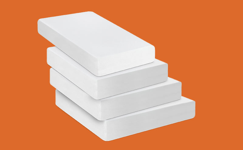 Stack of white mattress toppers on an orange background